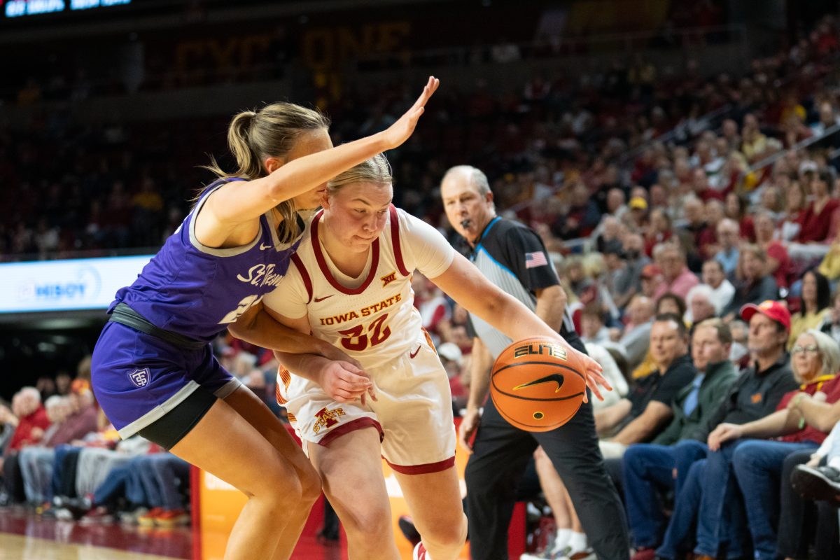 Aili Tanke (32) dribbles the ball against defender Alyssa Sand (24) during the game vs. University of St. Thomas, Hilton Coliseum, Ames, Iowa, Nov. 14, 2024.