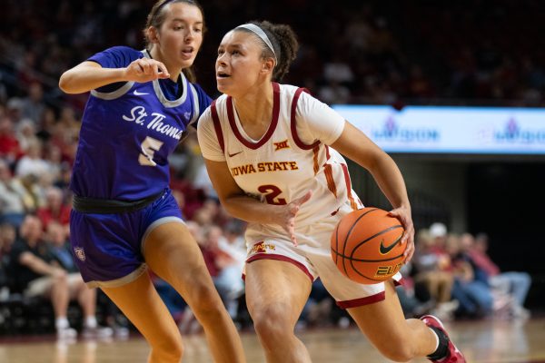 Arianna Jackson (2) makes a drive towards the hoop against defender Faith Feuerbach (5) during the game vs. University of St. Thomas, Hilton Coliseum, Ames, Iowa, Nov. 14, 2024. 