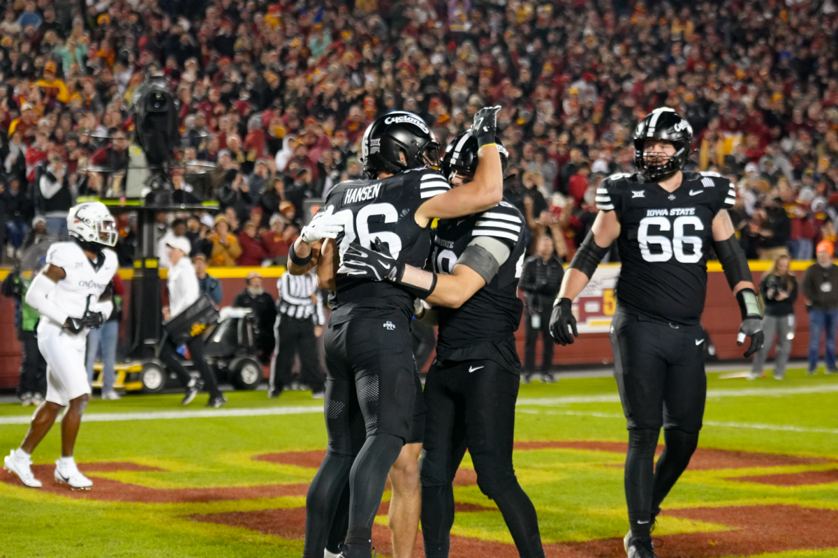 Carson Hanson (26) celebrates a touchdown with teammates, Jack Trice Stadium, Nov. 16, 2024.