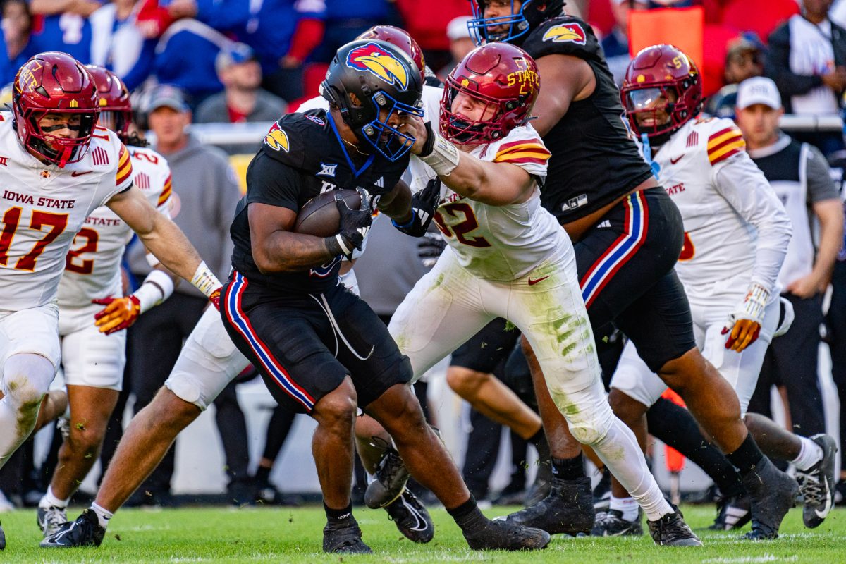 Iowa State DE Joey Petersen (52) grabs the face mask of Daniel Hishaw Jr. (9) during the Iowa State vs. University of Kansas football game on Nov. 9, 2024, GEHA Field at Arrowhead Stadium.