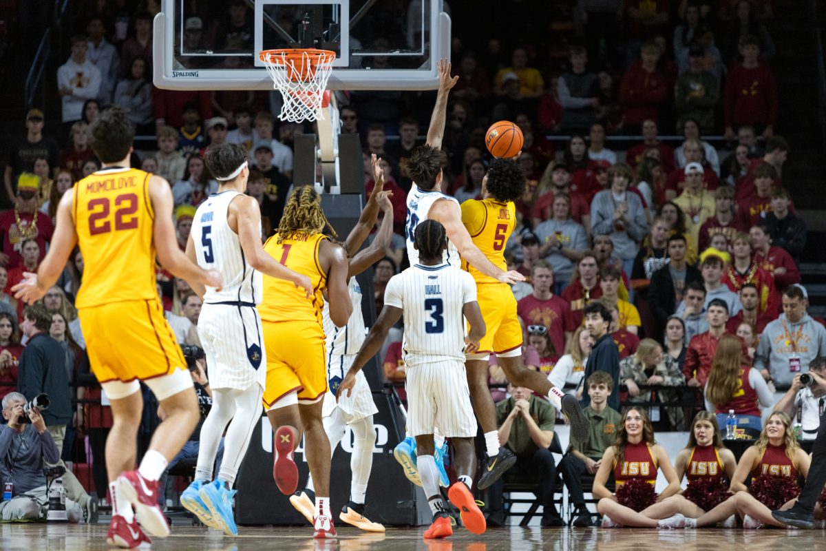 Curtis Jones (5) goes for a layup against Cameron Faas (30) during the first half of the Iowa State Cyclones vs. the Kansas City Roos game at Hilton Coliseum in Ames, Iowa on Nov. 11, 2024.