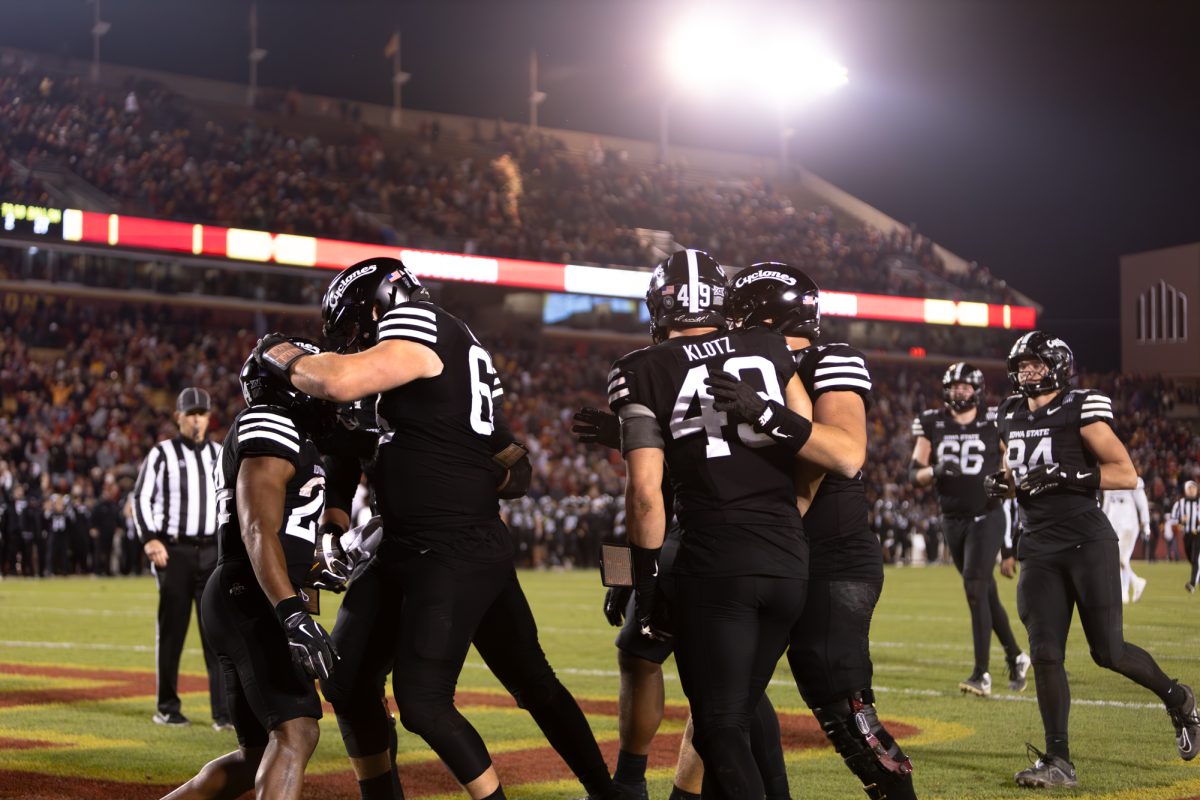 From left to right: Abu Sama III (24) celebrates with Jim Bonifas (63), Stevo Klotz (49) and Trevor Buhr (70) after scoring a touchdown late in the fourth quarter during the Iowa State Cyclones and Cincinnati Bearcats game in Ames Iowa on Nov. 16, 2024.