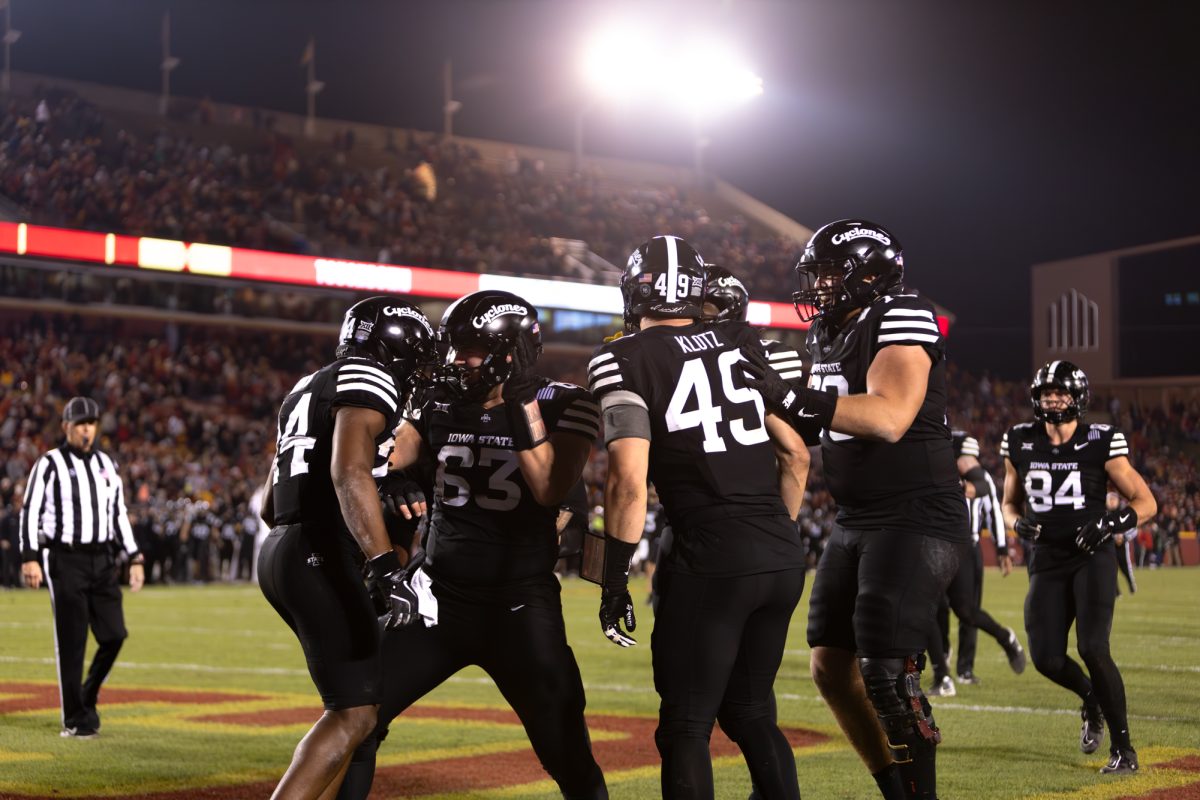 From left to right: Abu Sama III (24) celebrates with Jim Bonifas (63), Stevo Klotz (49) and Trevor Buhr (70) after scoring a touchdown late in the fourth quarter during the Iowa State Cyclones and Cincinnati Bearcats game in Ames Iowa on Nov. 16, 2024.