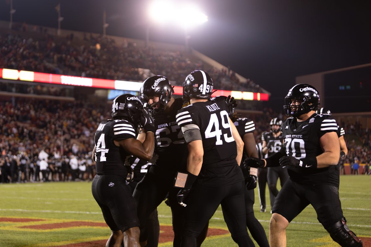 From left to right: Abu Sama III (24) celebrates with Jim Bonifas (63), Stevo Klotz (49) and Trevor Buhr (70) after scoring a touchdown late in the fourth quarter during the Iowa State Cyclones and Cincinnati Bearcats game in Ames Iowa on Nov. 16, 2024.