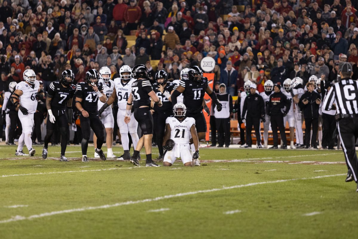 Kalen Carroll (21) kneels on the field after slipping while attempting to run the ball during the Iowa State Cyclones and Cincinnati Bearcats game in Ames Iowa on Nov. 16, 2024.