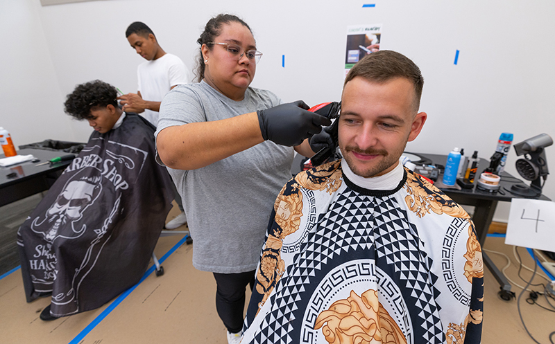 "Michael Bayer, a graduate student in mechanical engineering, receives a haircut from Samantha Hernandez, a Des Moines barber, in Parks Library's Cyclone Support Central Tuesday morning," according to Inside Iowa State. Sept. 24, 2024.