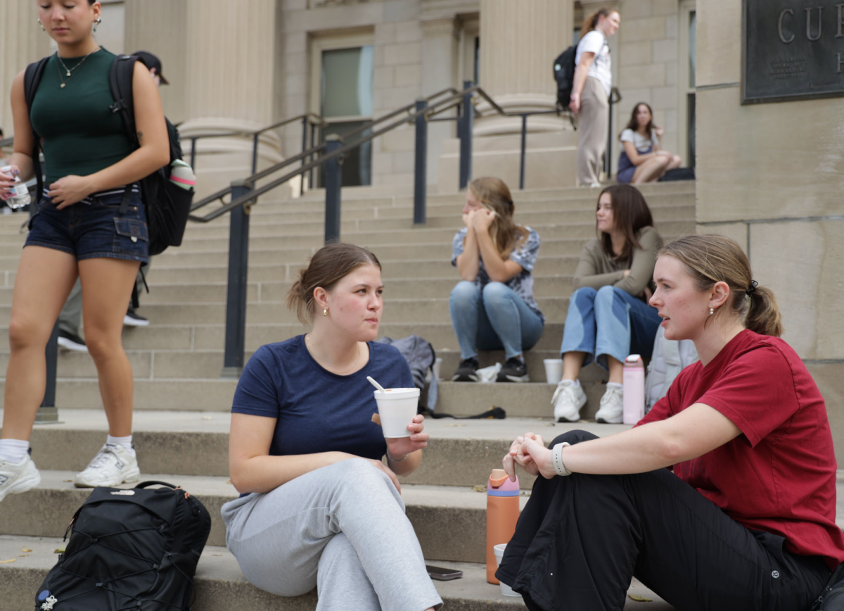 Samantha Zeeck (left) and Allison Miner (right) enjoy their chili and cinnamon rolls on the steps of Curtiss Hall on Oct. 29, 2024. Catered by the Machine Shed, the food is part of Iowa State's Food on Campus program to celebrate Homecoming Week. Anyone can purchase a $5 pin for five meals from various restaurants throughout the week.