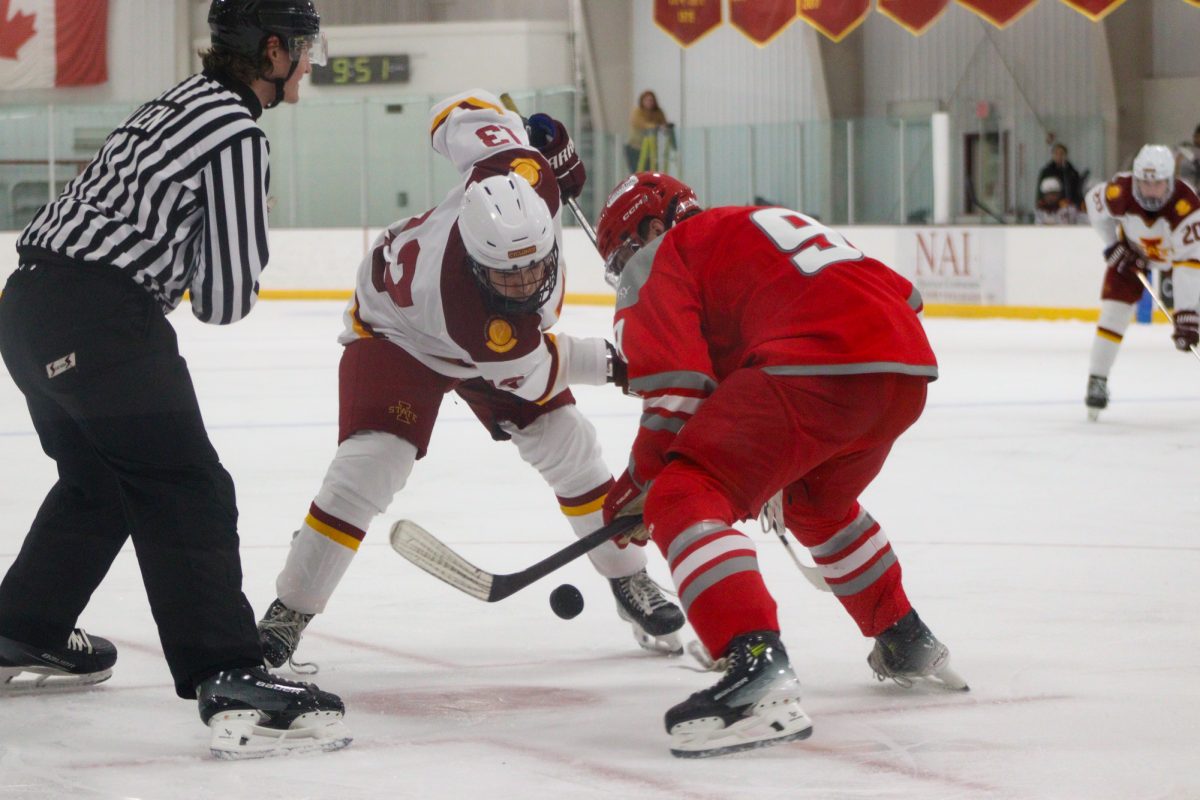 Iowa State men's hockey club player, Sam Eaton (13), faces off against Drury University's, K-T Walters (9). Ames/ISU Ice Arena Dec 7th 2024.