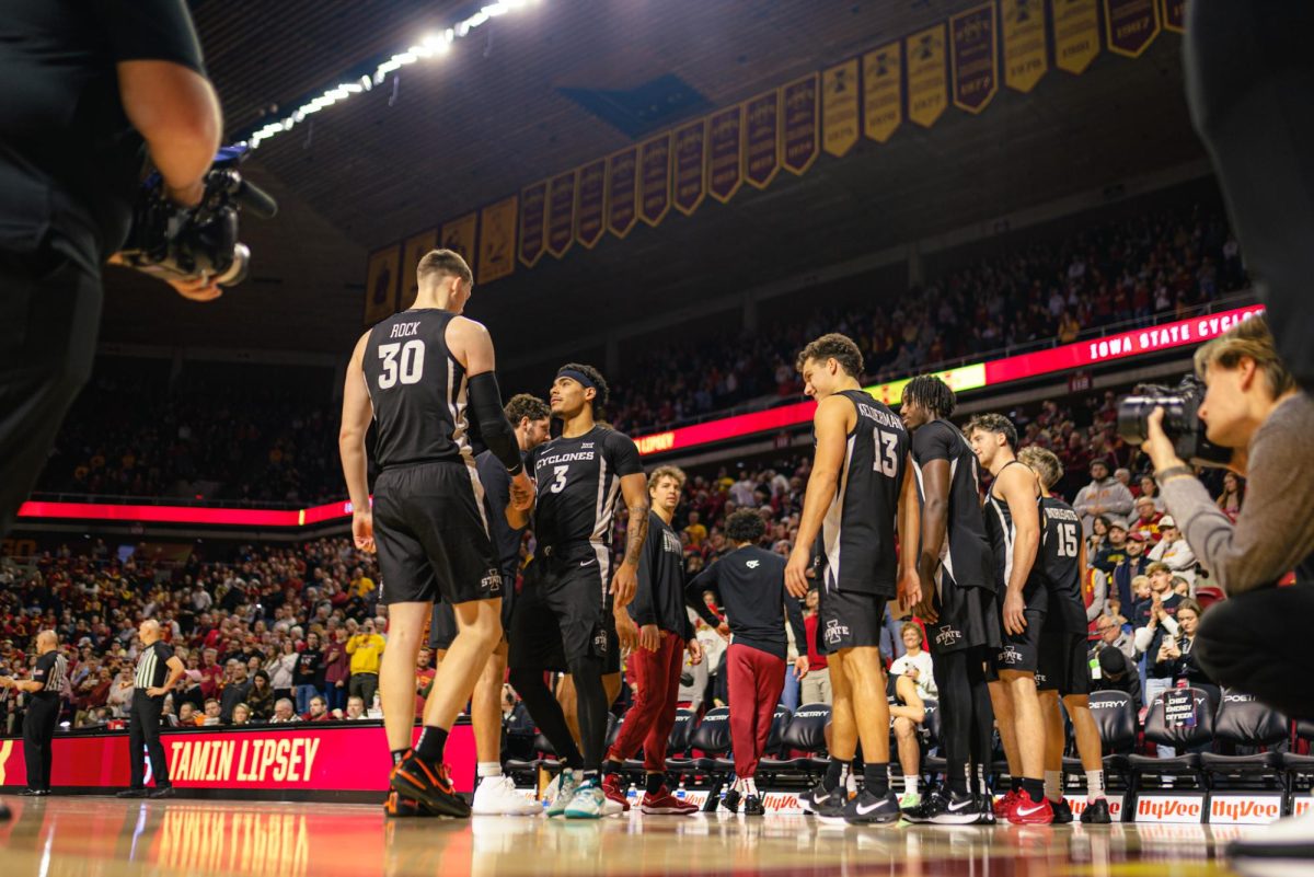 Tamin Lipsey (3) and JT Rock (30) shake hands during the starting lineups during the Morgan State University NCAA men's basketball game at Hilton Coliseum on Sunday, Dec. 22, 2024, in Ames, Iowa.