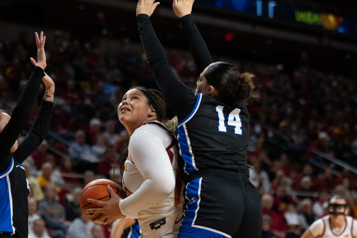 Audi Crooks (55) looks to shoot the ball while being guarded by Ellie Colson (14) during the game vs. Eastern Illinois,Hilton Coliseum, Ames, Iowa, Dec. 15, 2024.