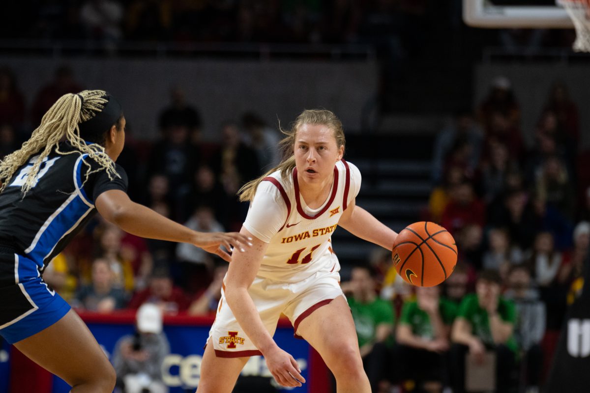 Emily Ryan (11) looks to pass the ball while being guarded by Tiny Lewis (21) during the game vs. Eastern Illinois, Hilton Coliseum, Ames, Iowa, Dec. 15, 2024.