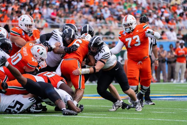 Cyclones tackle Miami's ball carrier during the game against the University of Miami in the Pop-Tarts Bowl, Camping World Stadium, Orlando, FL, Dec. 28, 2024.