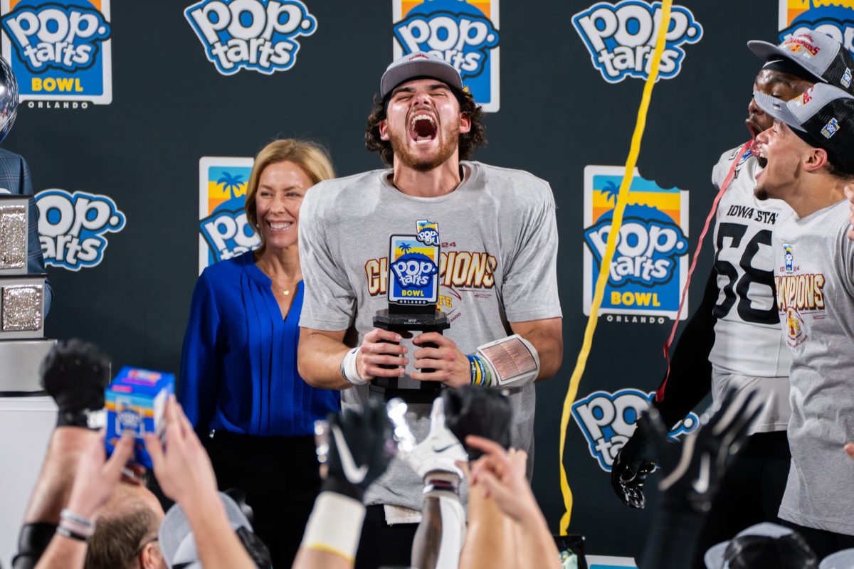 Rocco Becht celebrates being awarded MVP during the Pop-Tarts Bowl trophy ceremony after Iowa State beat the University of Miami 42-41, Camping World Stadium, Orlando, Florida, Dec. 28, 2024.