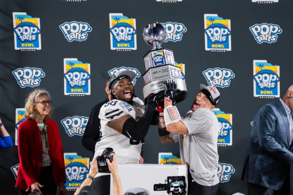 J.R. Singleton (58) and Jaylin Noel celebrates during the Pop-Tarts Bowl trophy ceremony after beating the University of Miami 42-41, Camping World Stadium, Orlando, FL, Dec. 28, 2024.