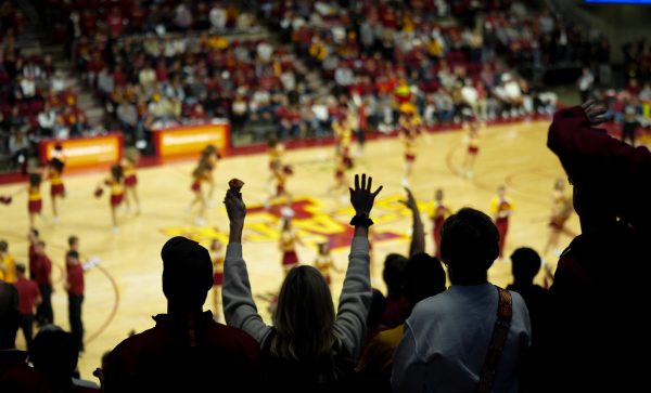 Fans throw their hands up in the air for a free t-shirt at the Iowa State men's basketball game vs. Jackson State University at Hilton Coliseum, Ames, Iowa, Dec. 8, 2024. 