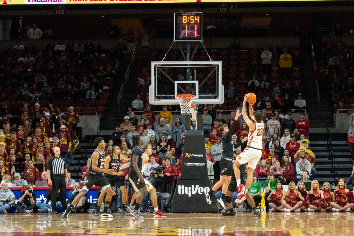 Milan Momcilovic (22) attempts a shot over a defender from the University of Nebraska Omaha, Hilton Coliseum, Dec. 15, 2024.