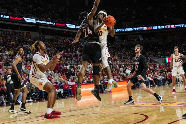 Iowa State men's basketball player Keshon Gilbert (10) gets blocked when jumping for a shot at the net by University of Nebraska Omaha Isaac Ondekane (24) at Hilton Coliseum, Dec. 15, 2024.