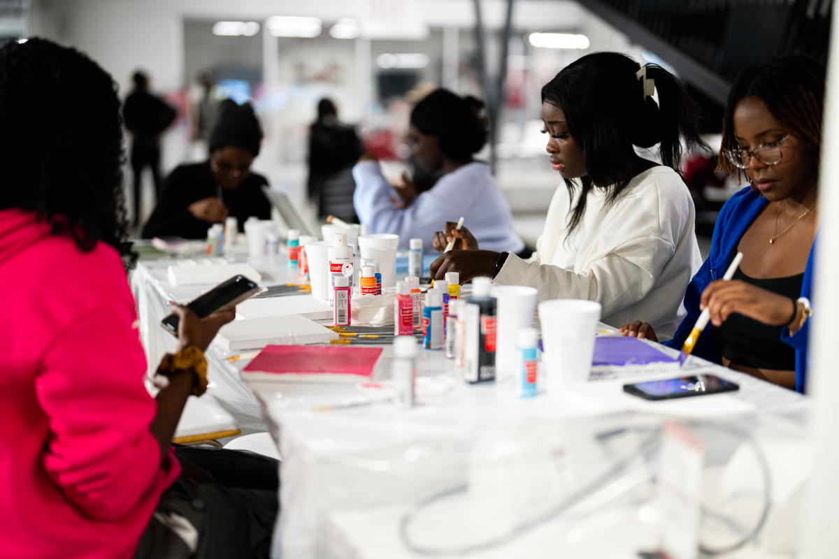 Iowa State students work on painting their canvases at the ASA (African Student Association) Paint and Sip night hosted on the first floor of the Student Innovation Center, Dec. 9, 2024.