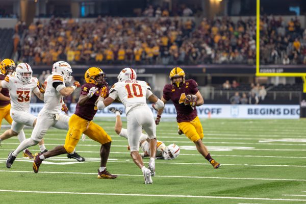 Darien Porter (10) goes for the tackle against Cam Skattebo (4) of the Arizona State Sun Devils during the championship game against at AT&T Stadium in Arlington Texas on December 7th, 2024.  