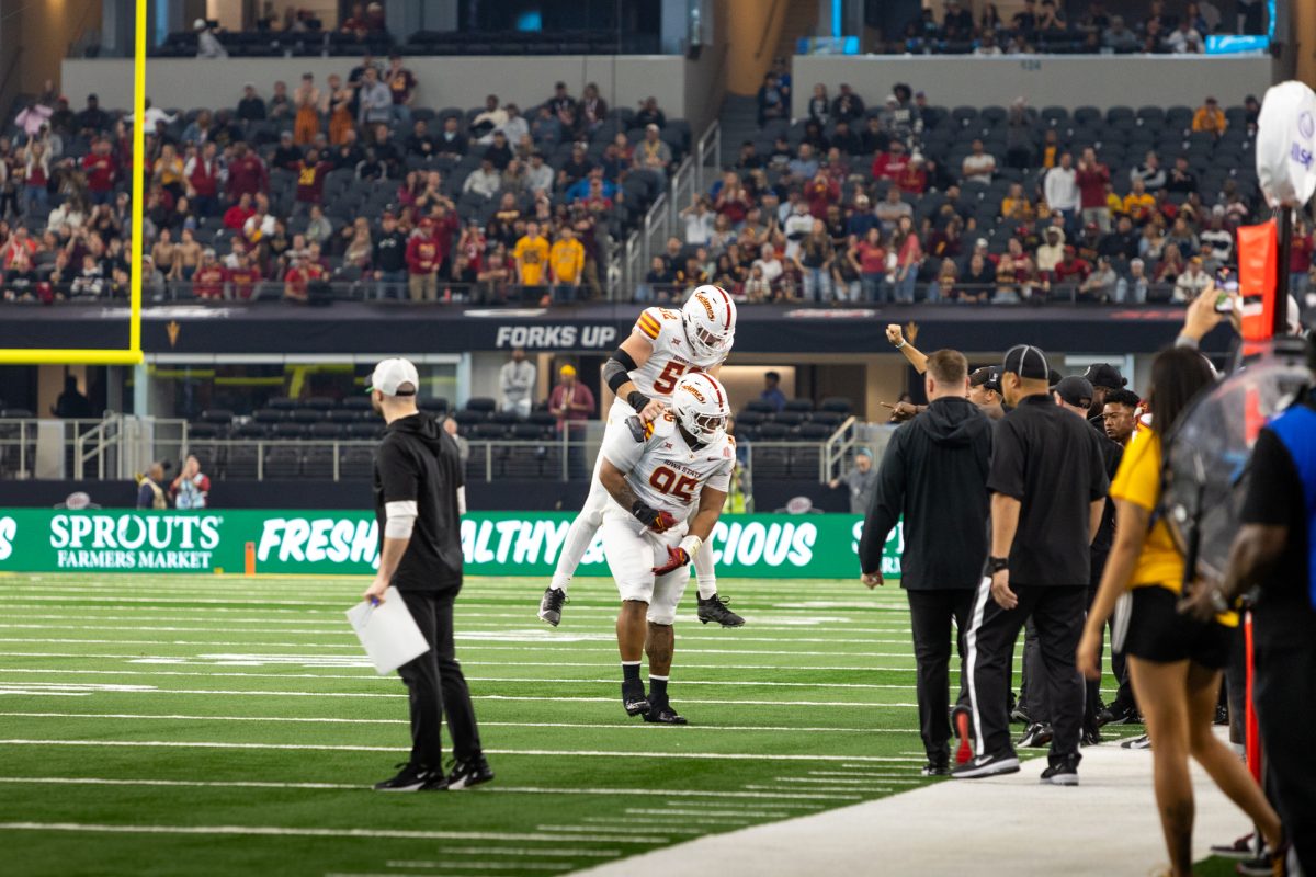 Joey Peterson (52) jumps on the back of Domonique Orange (95) after he successfully sacks the Arizona State Sun Devils quarterback during the championship game at AT&T Stadium in Arlington Texas on December 7th, 2024.  