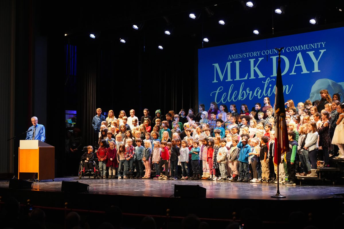 Charles Grim introduces the Meeker/Edwards and Ames Youth Choir Elementary Students (MLK Children's Choir) at the Ames/Story County Community MLK Day 2025 Celebration, Ames City Hall Auditorium, Jan. 20, 2025.