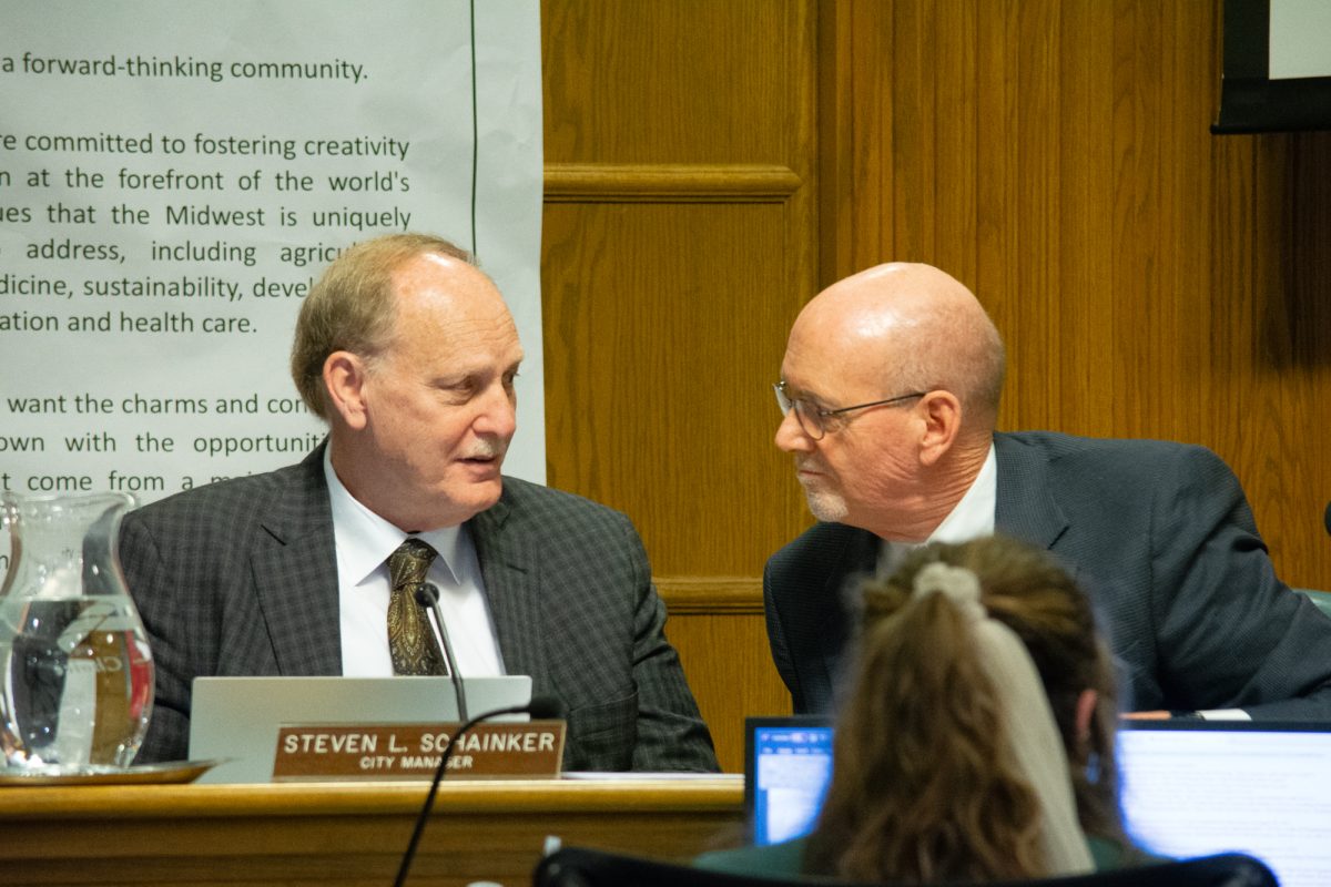 City Manager Steven L. Schainker speaks with Mayor John Haila during the Ames City Council Meeting, Ames City Hall, Ames, Iowa, Jan. 28, 2025.