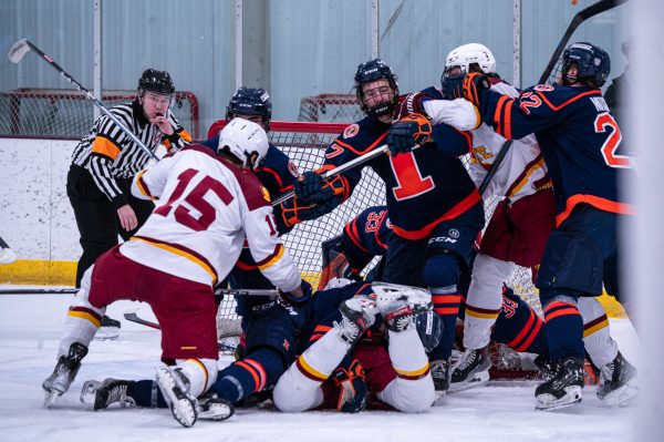 Iowa State men's hockey club players end up in a dog pile in front of the visiting University of Illinois goalie at Ames ice arena, Jan. 25, 2025.