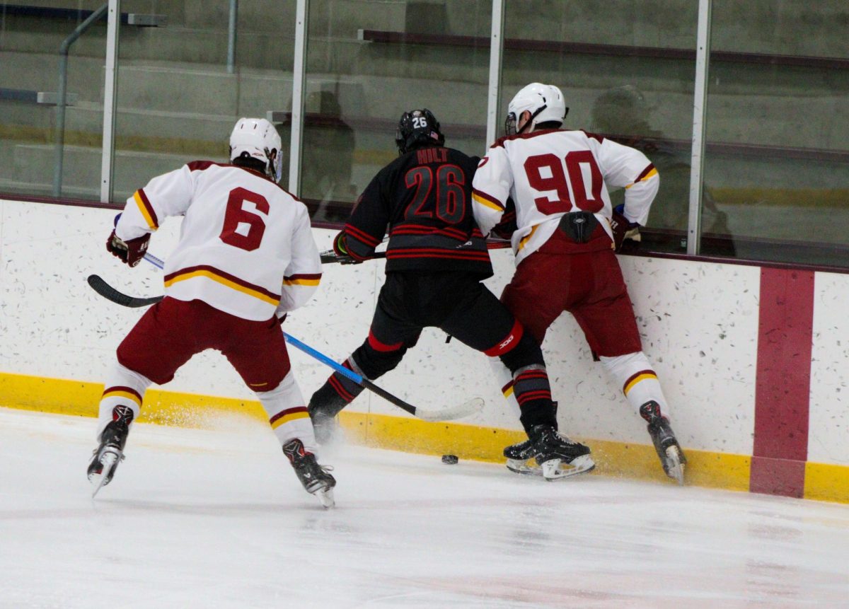 Two Iowa State club hockey players pressure an Illinois State player against the boards, Ames/ISU Ice Arena, Jan. 25, 2025.