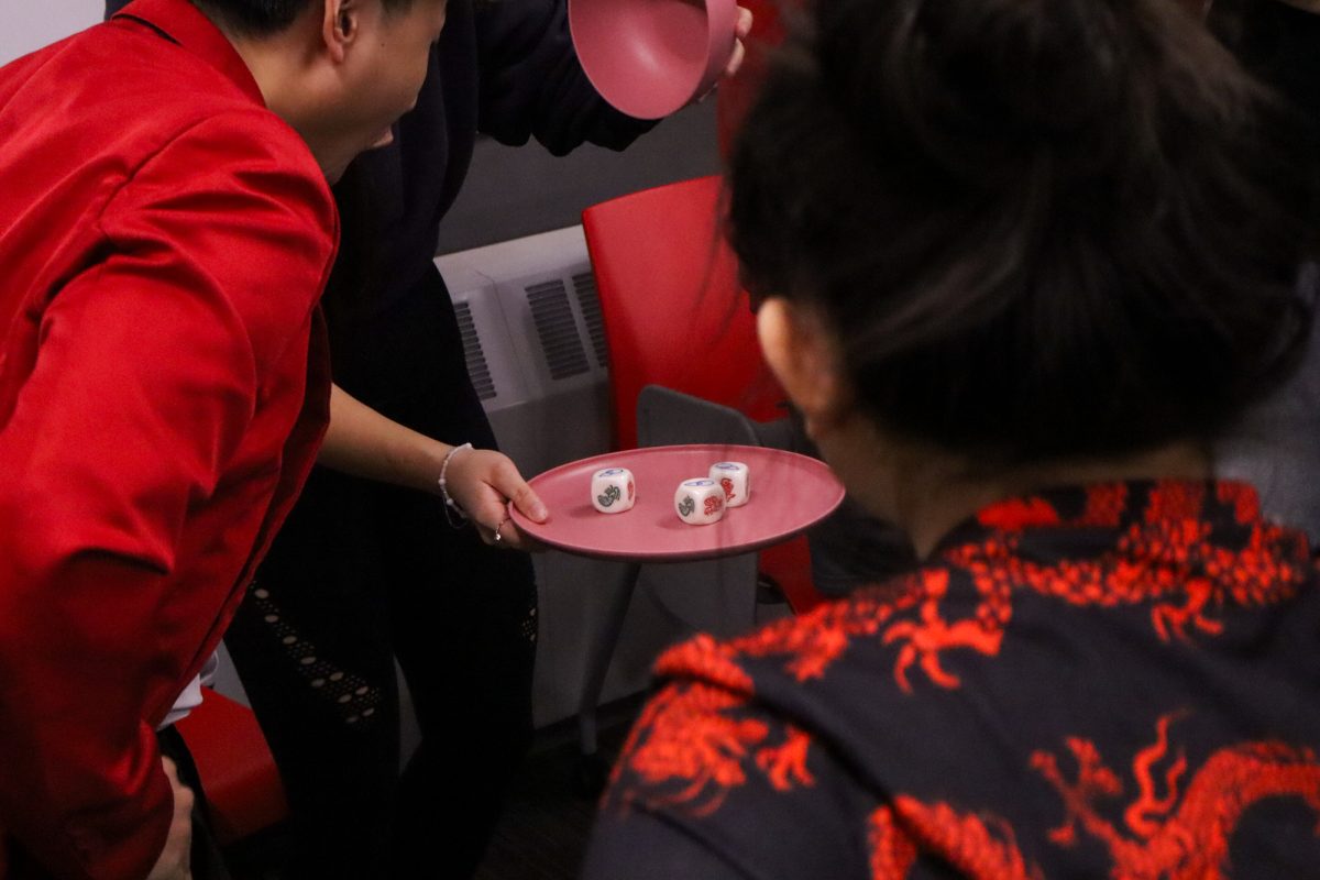 Players shocked at the results of the dice during a game of Bau Cua Ca Cop at the Lunar New Year event, taken on January 29, 2025, at Pearson hall at Iowa State University.