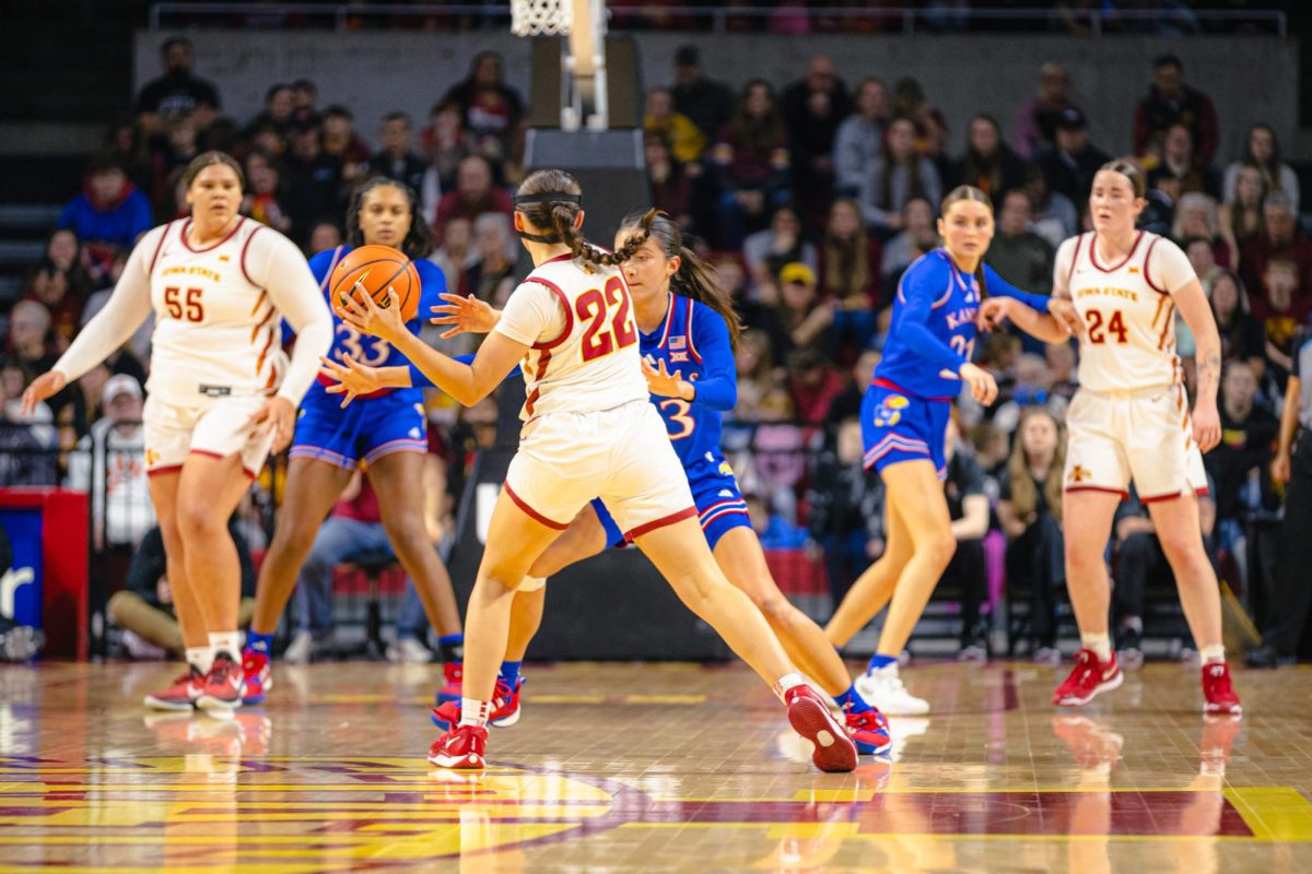 Reagan Wilson (22) looks for an opening on the court during the Iowa State vs. University of Kansas NCAA women's basketball game at Hilton Coliseum on Wednesday, Jan. 1, 2025, in Ames, Iowa.