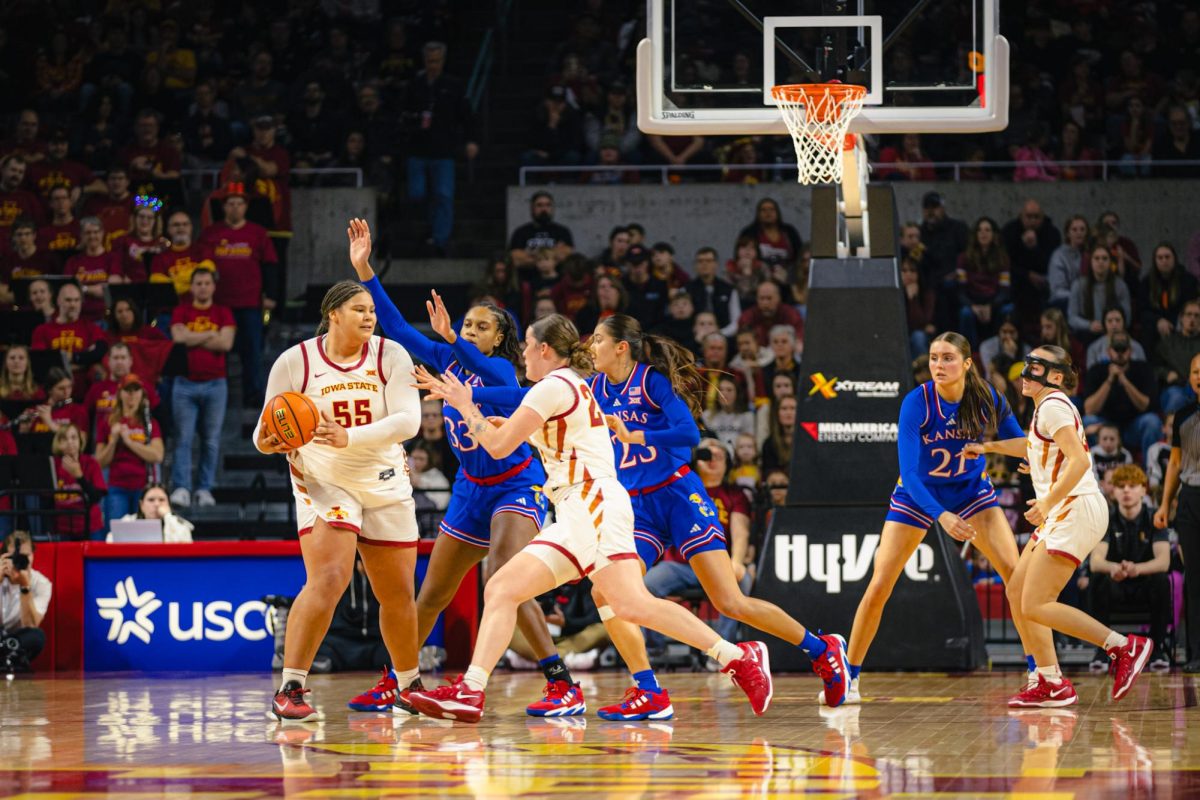 Audi Crooks (55) looks for an opening on the court during the Iowa State vs. University of Kansas NCAA women's basketball game at Hilton Coliseum on Wednesday, Jan. 1, 2025, in Ames, Iowa.