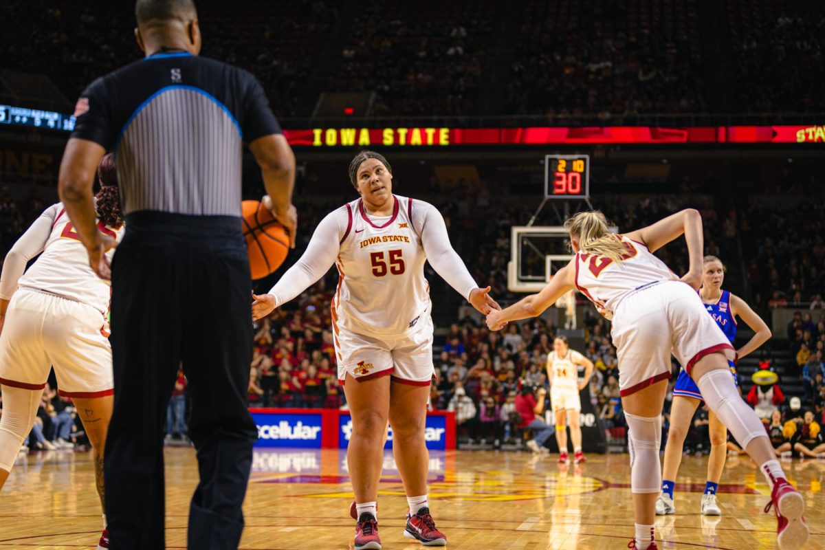 Audi Crooks (55) gives high fives after shooting a free throw during the Iowa State vs. University of Kansas NCAA women's basketball game at Hilton Coliseum on Wednesday, Jan. 1, 2025, in Ames, Iowa.