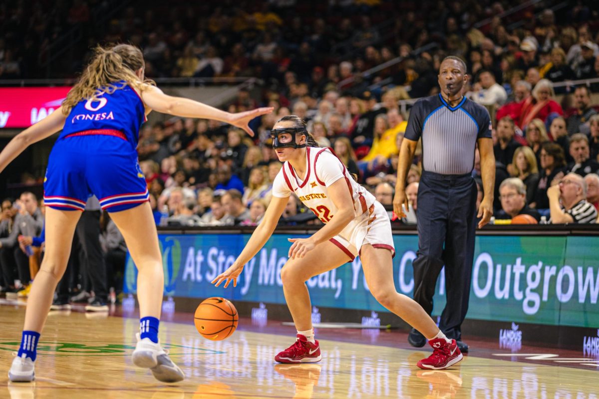 Reagan Wilson (22) looks for an opening on the court during the Iowa State vs. University of Kansas NCAA women's basketball game at Hilton Coliseum on Wednesday, Jan. 1, 2025, in Ames, Iowa.
