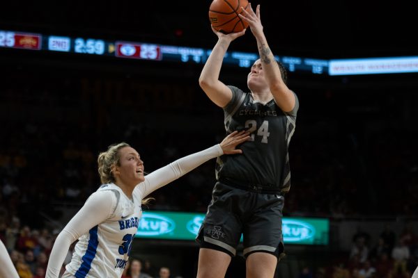 Addy Brown (24) shoots the ball while being guarded by defender Lauren Davenport (30) during the game vs. Brigham Young University, Hilton Coliseum, Ames, Iowa, Jan. 22, 2025. 