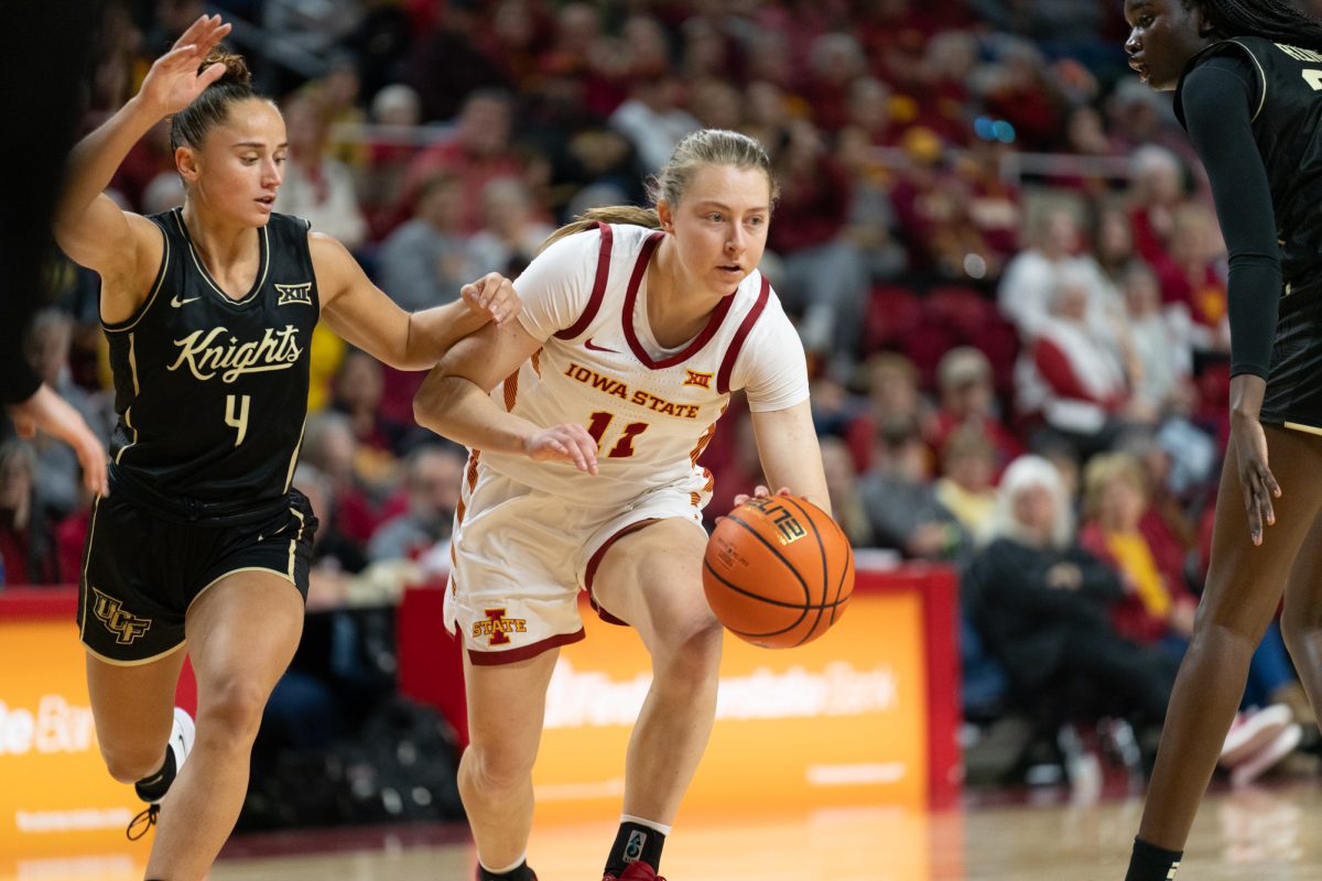 Emily Ryan (11) drives the ball toward the hoop while being defended by Lucie Castagne (4) during the game vs. University of Central Florida, Hilton Coliseum, Ames, Iowa, Jan. 25, 2025.