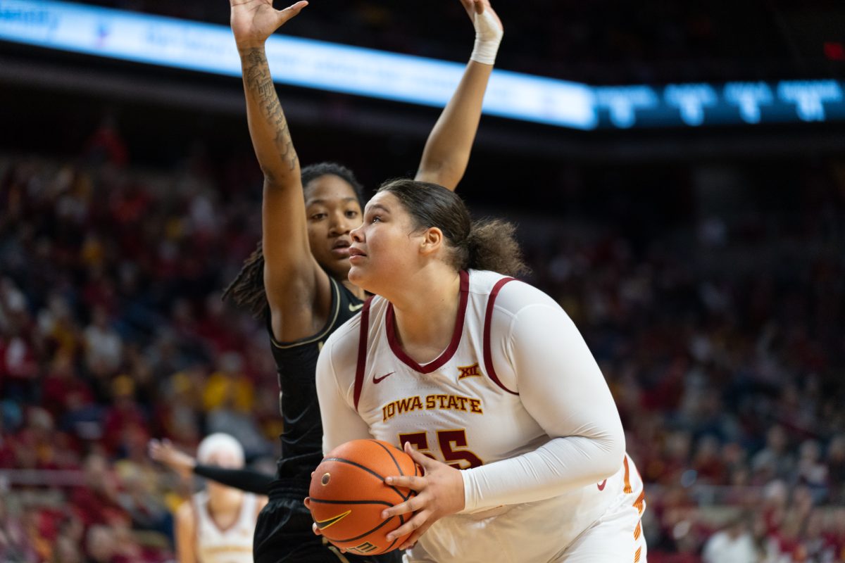 Audi Crooks (55) looks to shoot the ball against defender Khyala Ngodu (35) during the game vs. University of Central Florida, Hilton Coliseum, Ames, Iowa, Jan. 25, 2025.