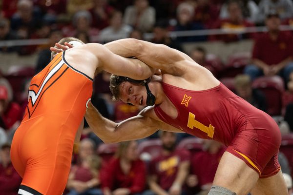 Evan Bockman (ISU) holds onto Dustin Plott (OSU) during the match vs. Oklahoma State University, Hilton Coliseum, Ames, Iowa, Jan. 26, 2025.