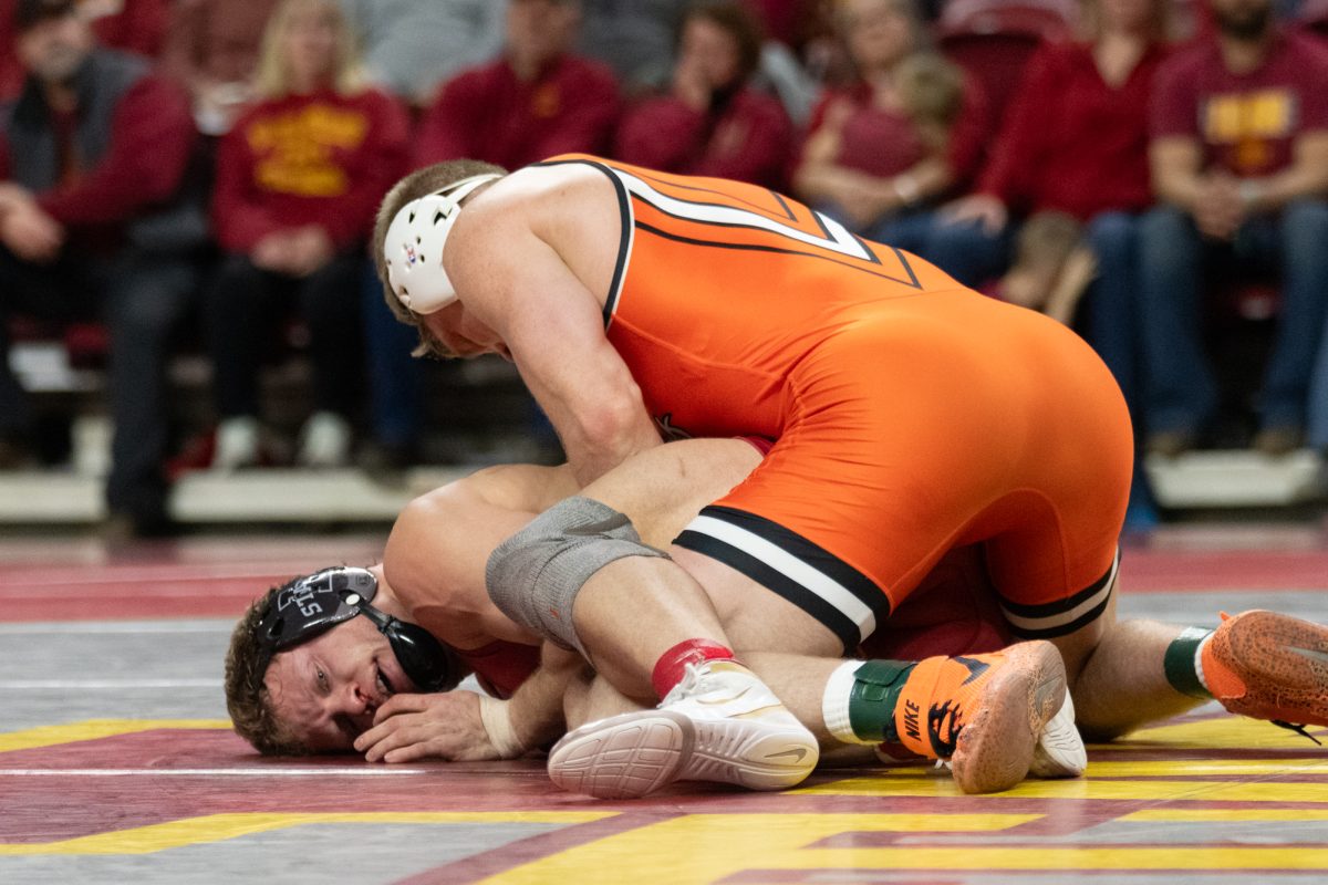 Evan Bockman (ISU) is pinned to the floor by Dustin Plott (OSU) during the match vs. Oklahoma State University, Hilton Coliseum, Ames, Iowa, Jan. 26, 2025.