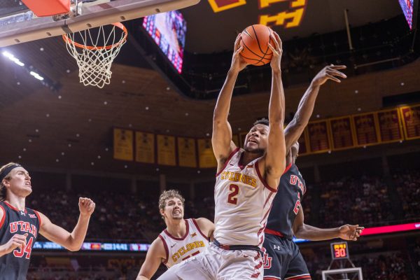 Joshua Jefferson (2) defensively rebounds and prevents Utah player Ezra Ausar (2) from repossessing the ball during the first half of the Iowa State vs. University of Utah game in Hilton Coliseum in Ames, Iowa on Jan. 7, 2025.  