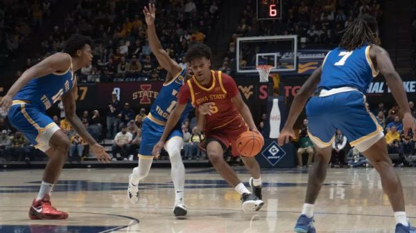 Curtis Jones (5) dribbles past West Virginia defenders in Morgantown on Jan. 18, 2025. // Photo provided by Iowa State Athletics