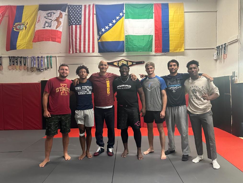 Kyven Gadson (middle) and members of Myriad MMA Academy pose for a photo.