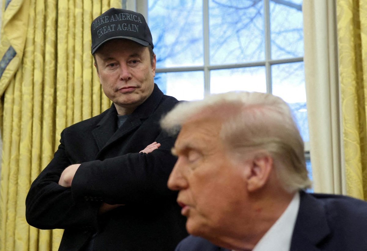 Elon Musk listens to U.S. President Donald Trump speak in the Oval Office of the White House in Washington, D.C., U.S., February 11, 2025. REUTERS/Kevin Lamarque