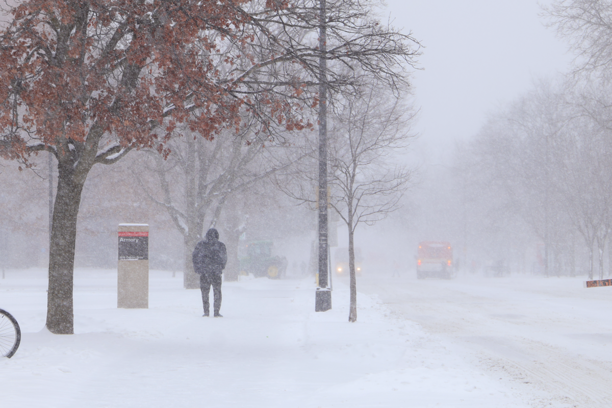 A student walks past the Armory in the snow, Feb. 12, 2025, Ames, Iowa.