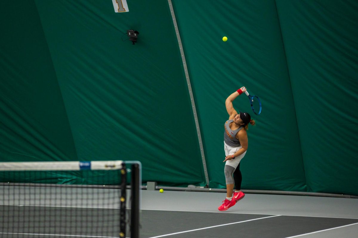 Anna Supapitch Kuearum serves the ball during the Iowa State University vs. University of Wyoming tennis meet, Feb. 8, 2025, Iowa State Tennis Center, Ames, Iowa. 