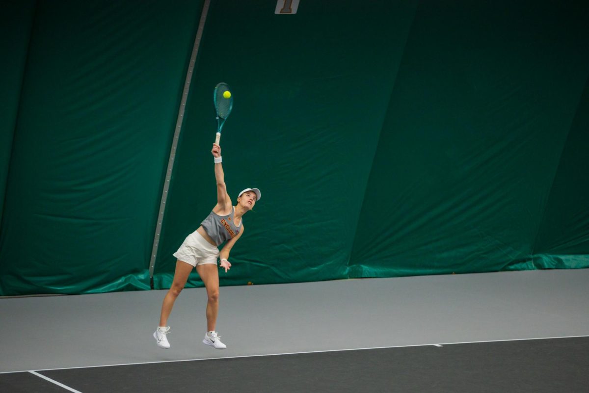 Christina Ramos Sierra serves the ball during the Iowa State University vs. University of Wyoming tennis meet, Feb. 8, 2025, Iowa State Tennis Center, Ames, Iowa. 