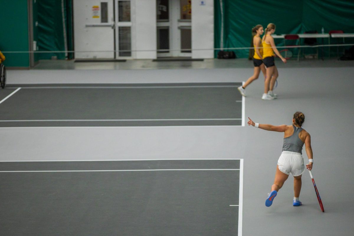 Gabriela Felix signals an out ball during the Iowa State University vs. University of Wyoming tennis meet, Feb. 8, 2025, Iowa State Tennis Center, Ames, Iowa. 