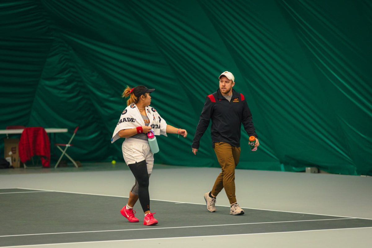 Anna Supapitch Kuearum and head coach Jaron Maestas talking during the Iowa State University vs. University of Wyoming tennis meet, Feb. 8, 2025, Iowa State Tennis Center, Ames, Iowa. 