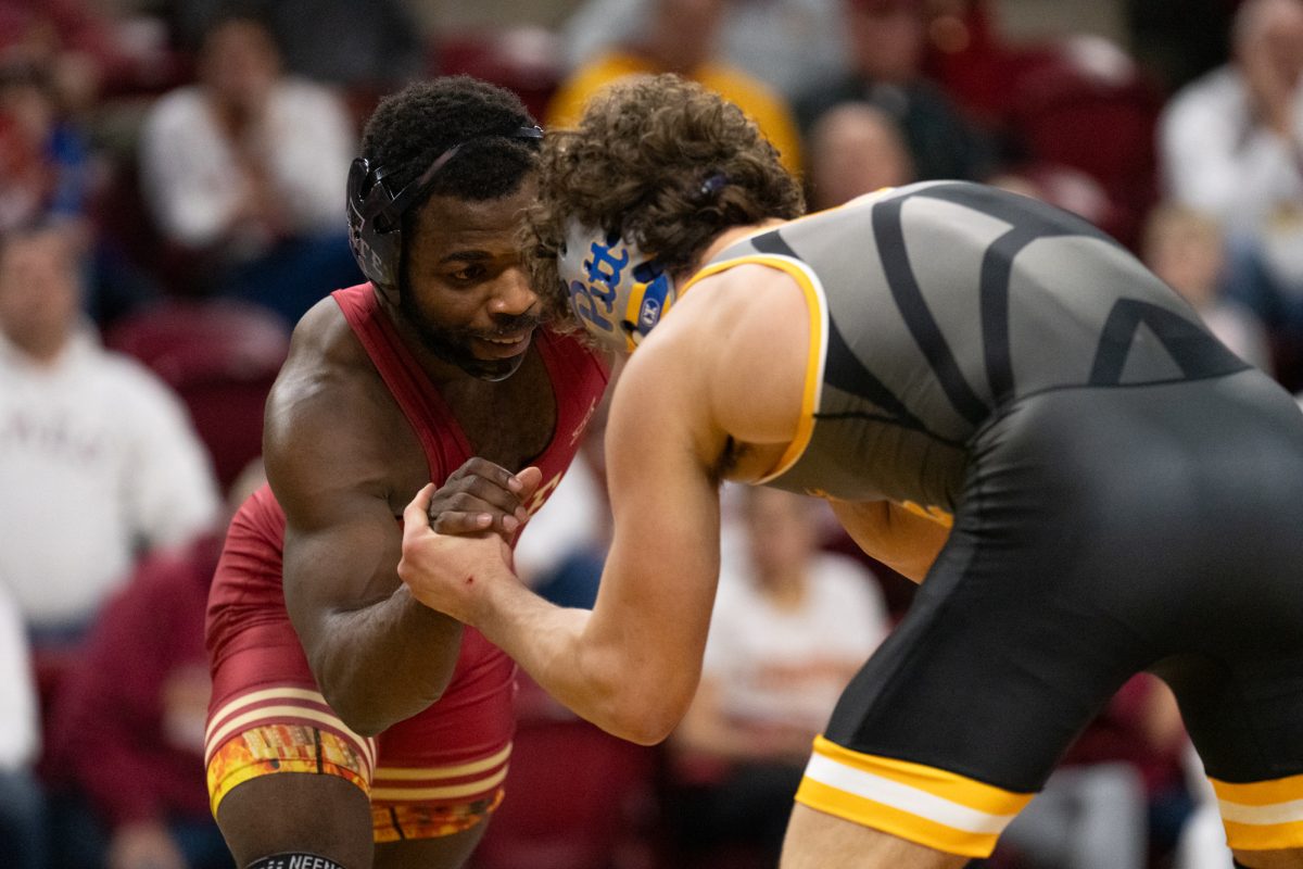 Paniro Johnson (ISU) and Pittsburgh's Kade Brown face off during the match vs. University of Pittsburgh on Feb. 9, 2025, Hilton Coliseum, Ames, Iowa.