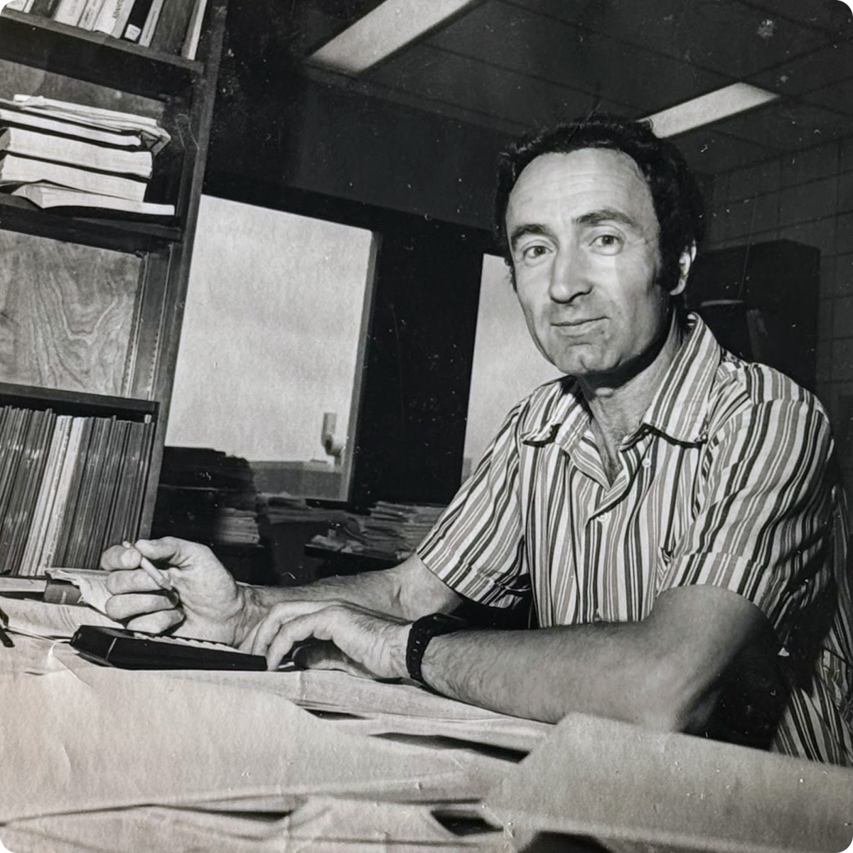 Photo of Vladimir Kogan working at his desk. Photo courtesy of Uri Kogan.