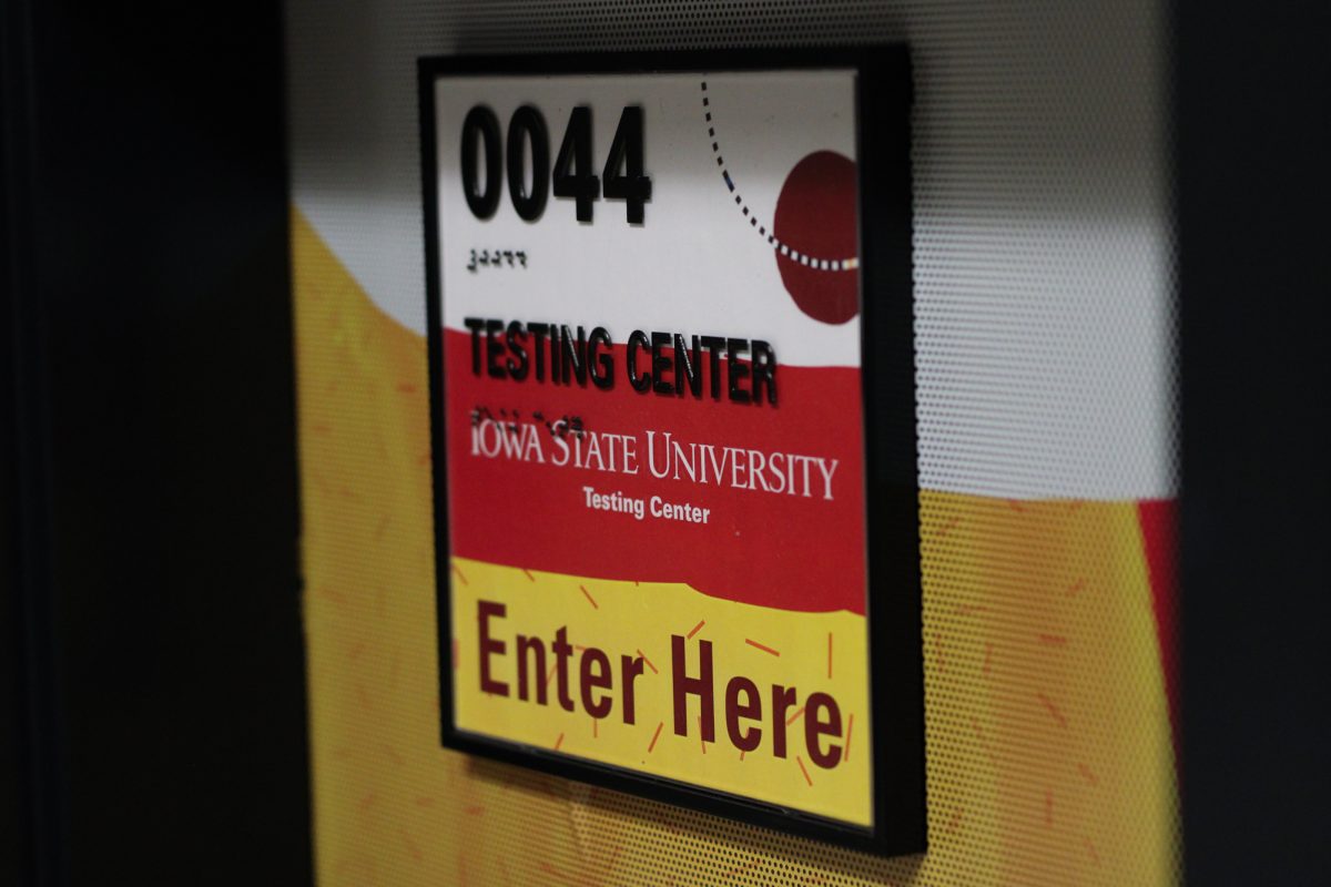 Testing center room number sign to enter here, taken on Mar. 11, 2025, Carver Hall, Ames, Iowa.  